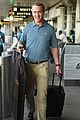 peyton manning arrives in new york with his suit in hand 03