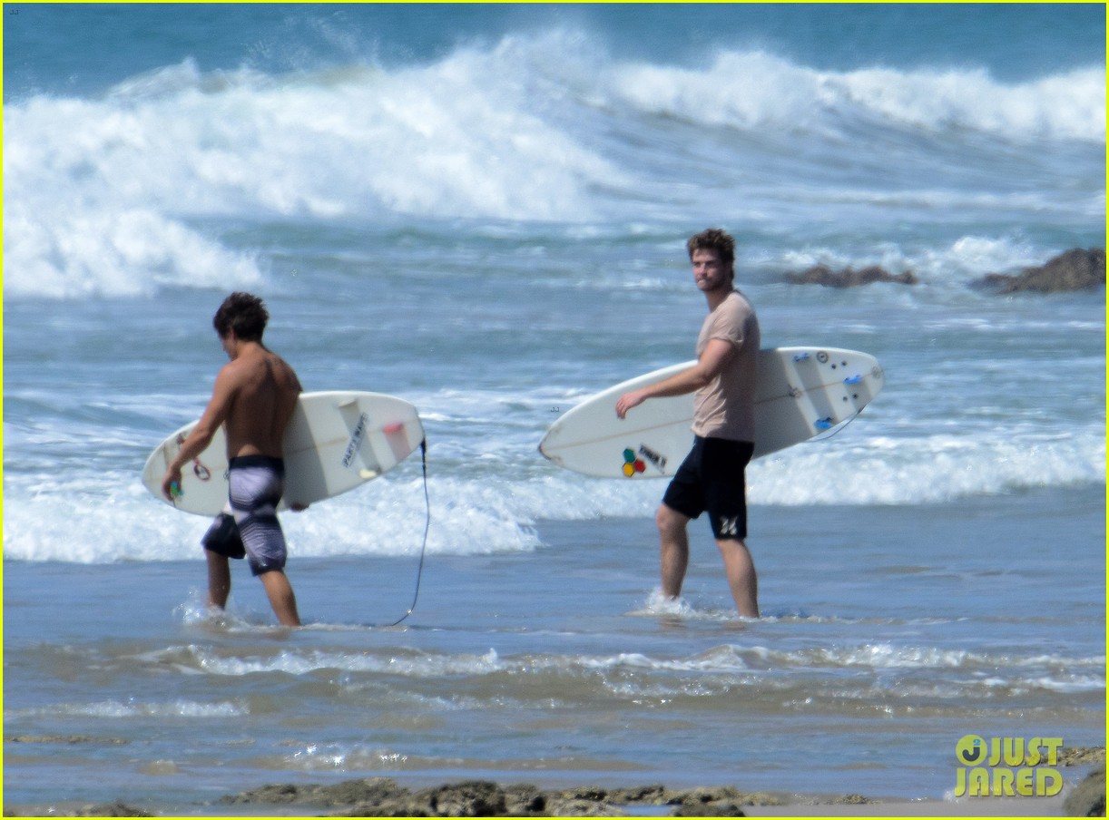 chris liam hemsworth shirtless surfing duo 112799388