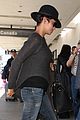 halle berry covers baby bump at lax 06