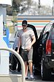 liam chris hemsworth filling up on gas groceries 03