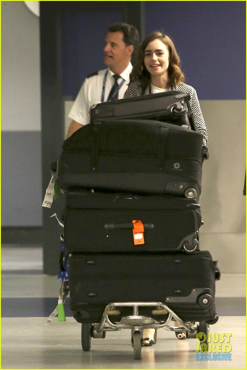 lily collins pushes giant luggage cart after mortals tour 032939604