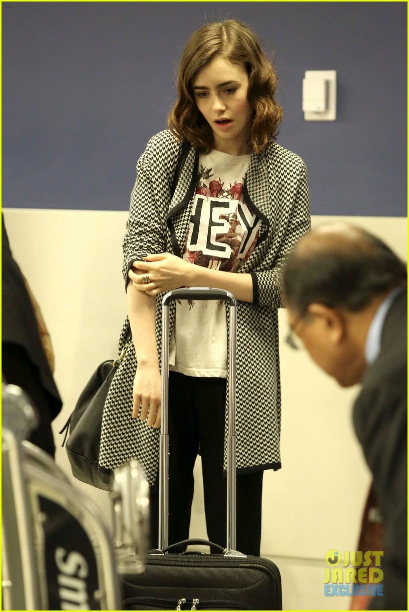 lily collins pushes giant luggage cart after mortals tour 20