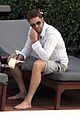 gerard butler relaxes at miami hotel pool with friends 03