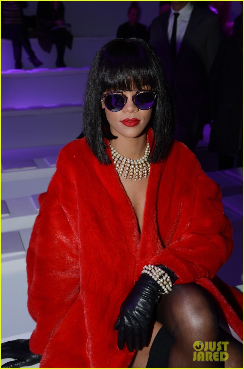 rihanna covers up sexy black outfit with red coat 16