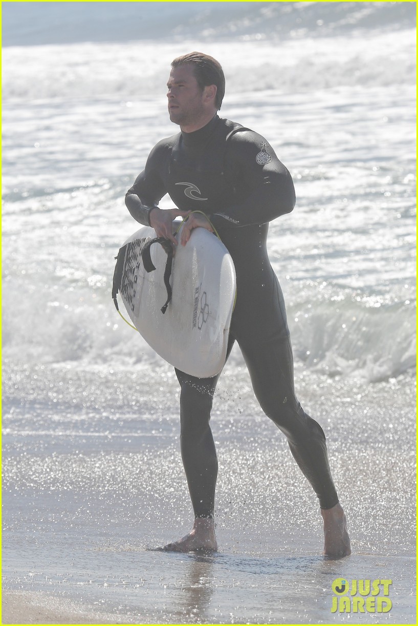 chris hemsworth makes us swoon while surfing in his tight wetsuit 243068892