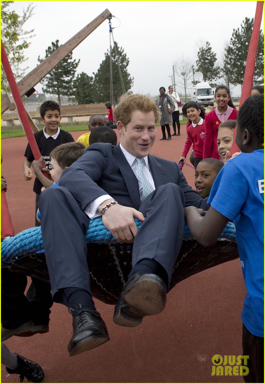 prince harry playing with kids at a playground 013084690