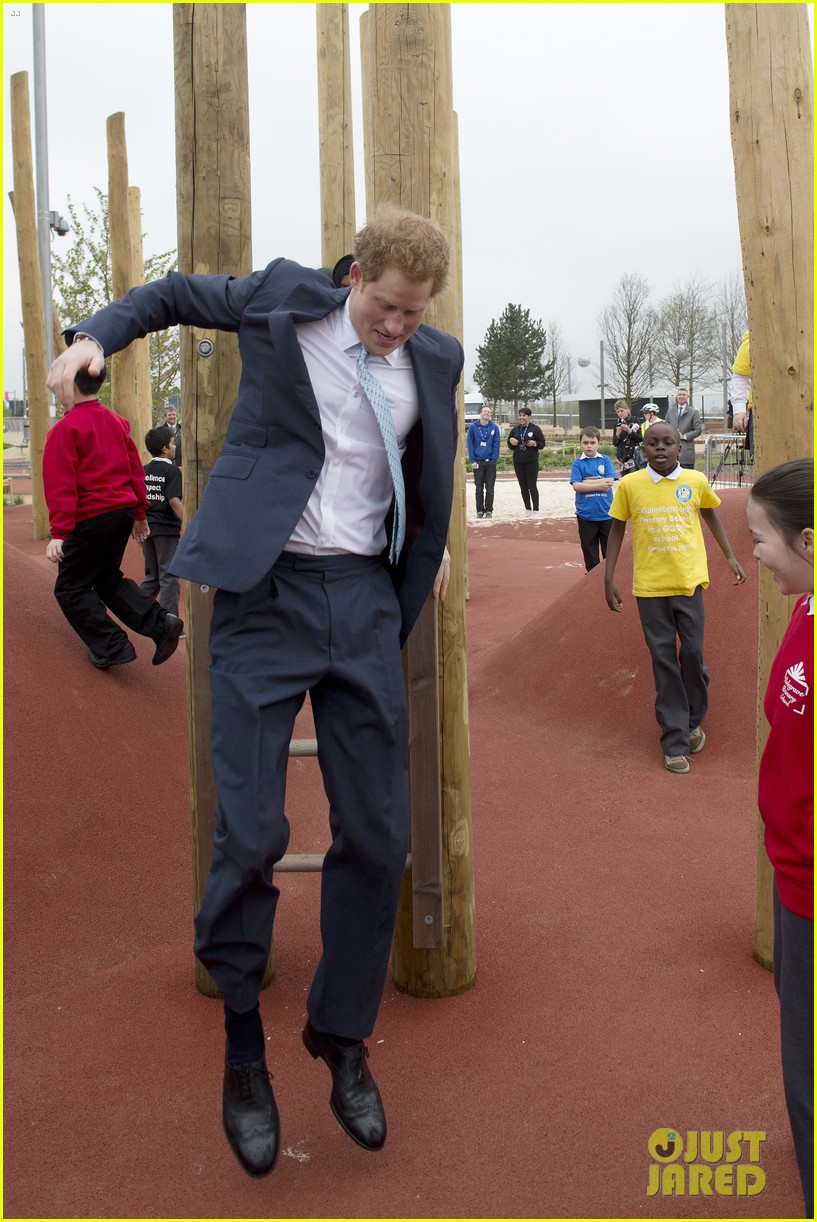prince harry playing with kids at a playground 073084696