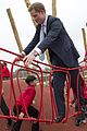 prince harry playing with kids at a playground 09
