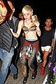 miley cyrus enters club fully clothed leaves in bra 05