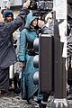 jennifer lawrence covers up her costume for hunger games 01