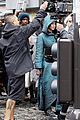 jennifer lawrence covers up her costume for hunger games 02