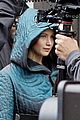 jennifer lawrence covers up her costume for hunger games 04
