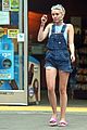 miley cyrus picks something off the ground gas station 06