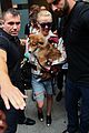 miley cyrus smiles wide with puppy moonie 01