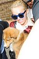 miley cyrus smiles wide with puppy moonie 04