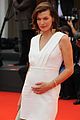 milla jovovich cradles baby bump at premiere 16