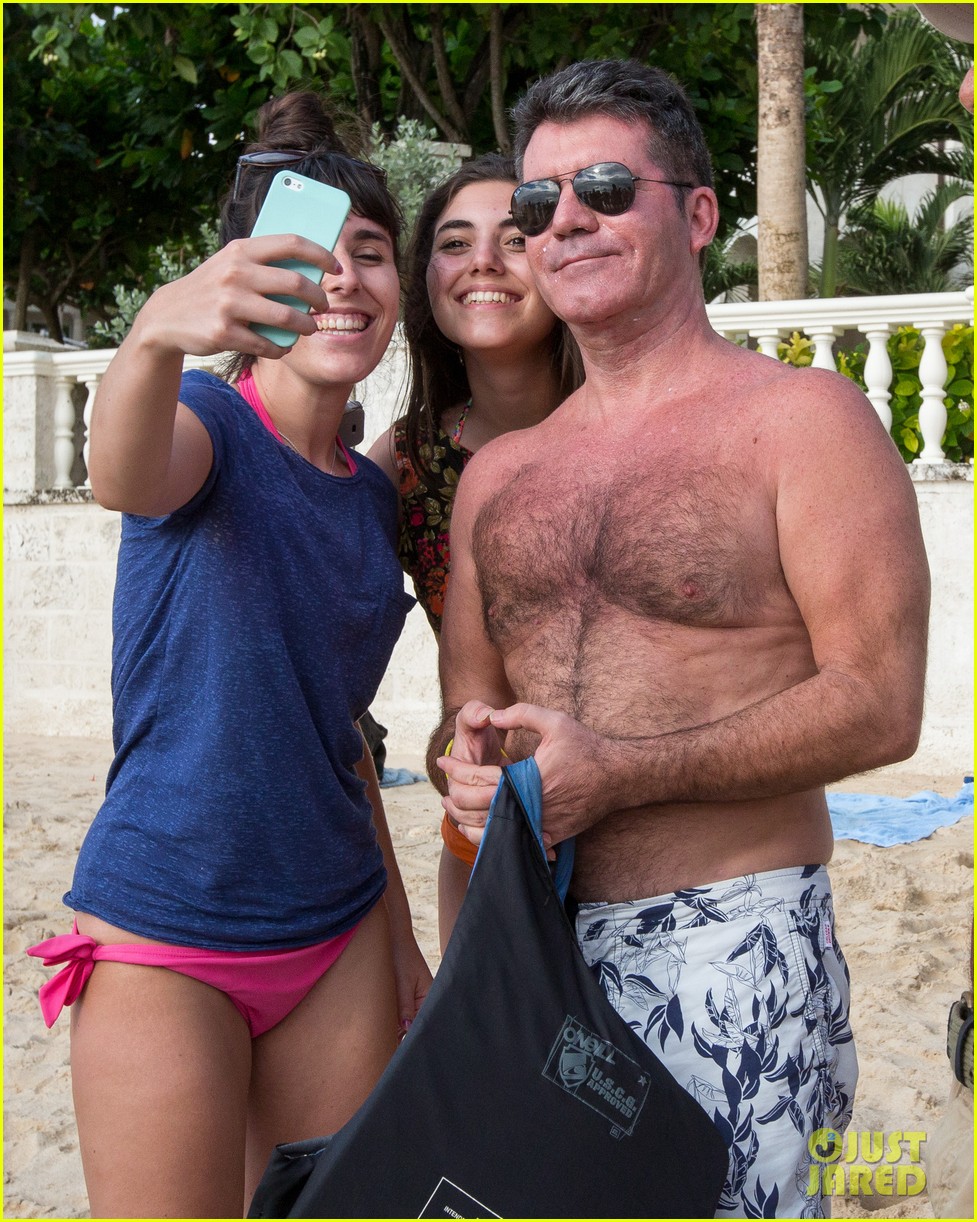 simon cowell takes selfies with fans on the beach 033269496