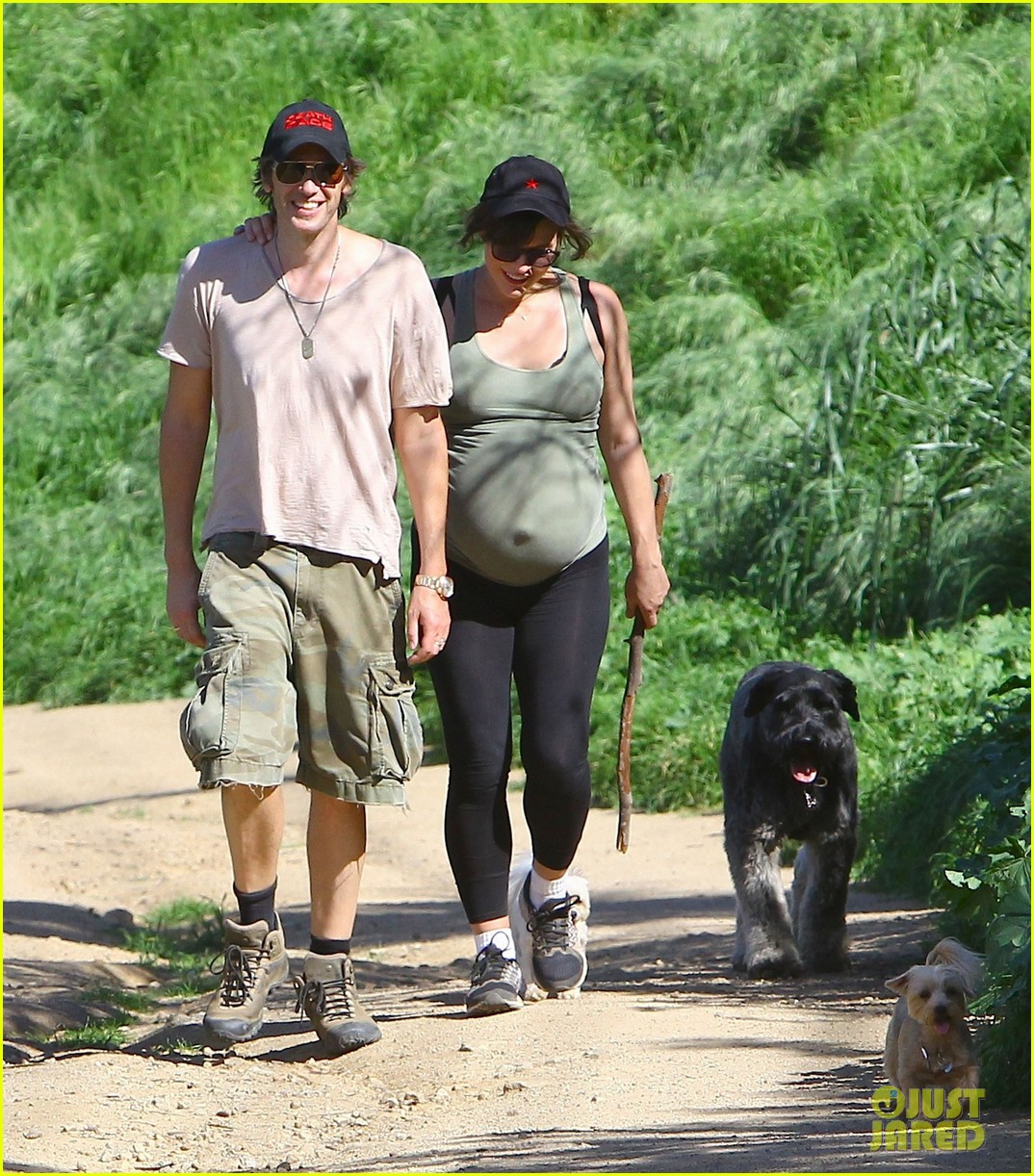 Pregnant Milla Jovovich Shows Off Her Growing Baby Bump While Rocking