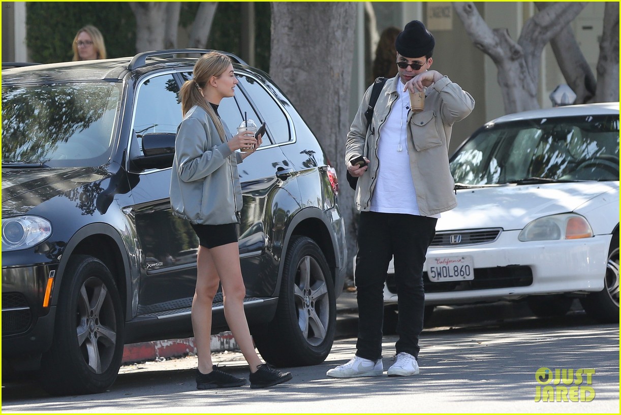 hailey baldwin holds sips on her coffee with her friend 133594337