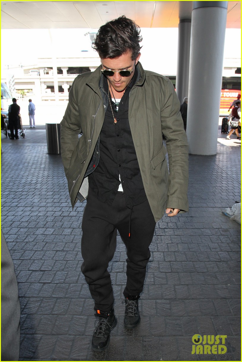 orlando bloom pulls off cool airport style for trip to paris 13