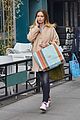 emily blunt hides baby bump shopping bags 01