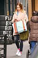 emily blunt hides baby bump shopping bags 03