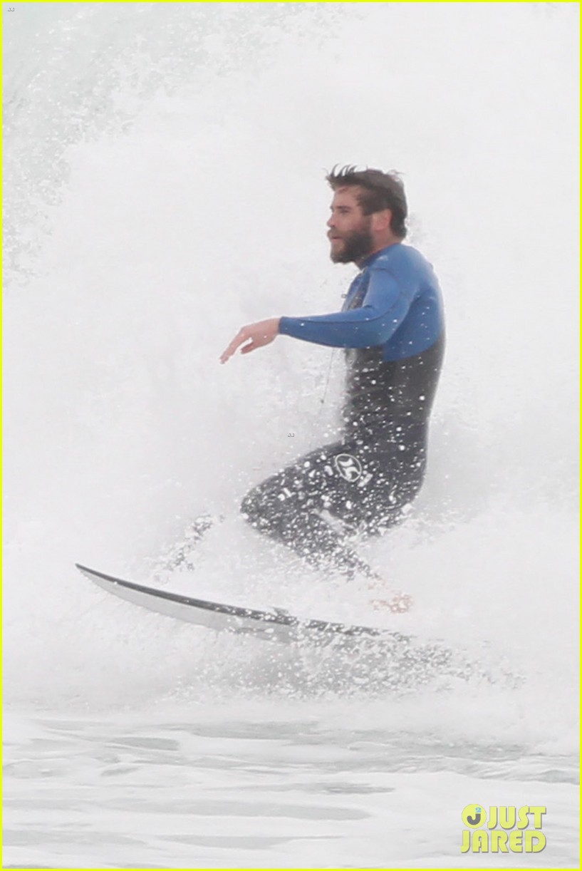 liam hemsworth strips out of his wetsuit after a surfing session 253661376