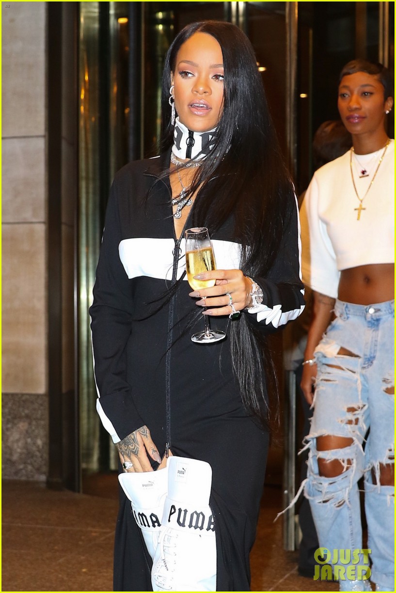 rihanna leaves her pop up shop with champagne in hand 11
