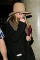 jennifer aniston covers up while arriving back in la 01