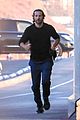 dad to be bradley cooper goes for a run on the beach 16