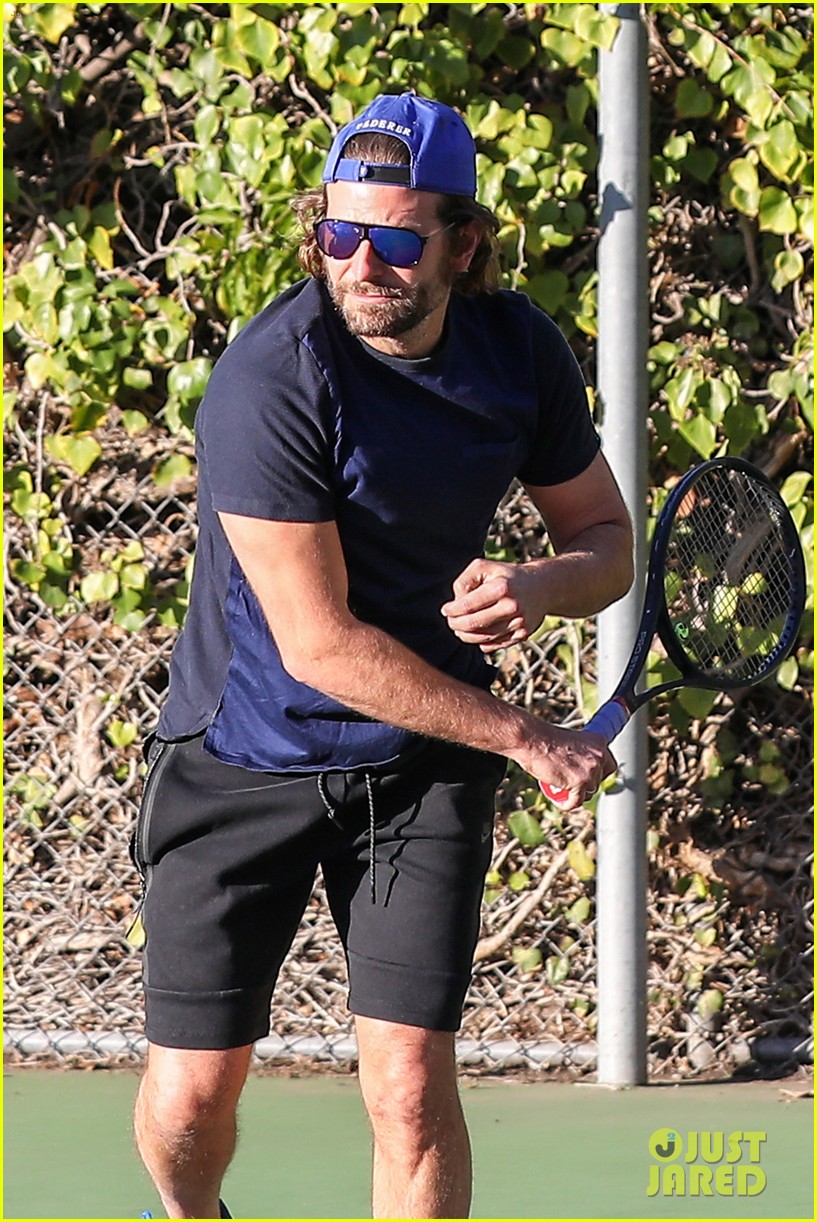 bradley cooper works on his serve on the tennis court 073834305