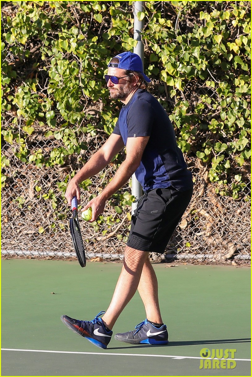 bradley cooper works on his serve on the tennis court 093834307