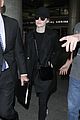 emma stone keeps a low profile while arriving at lax 02