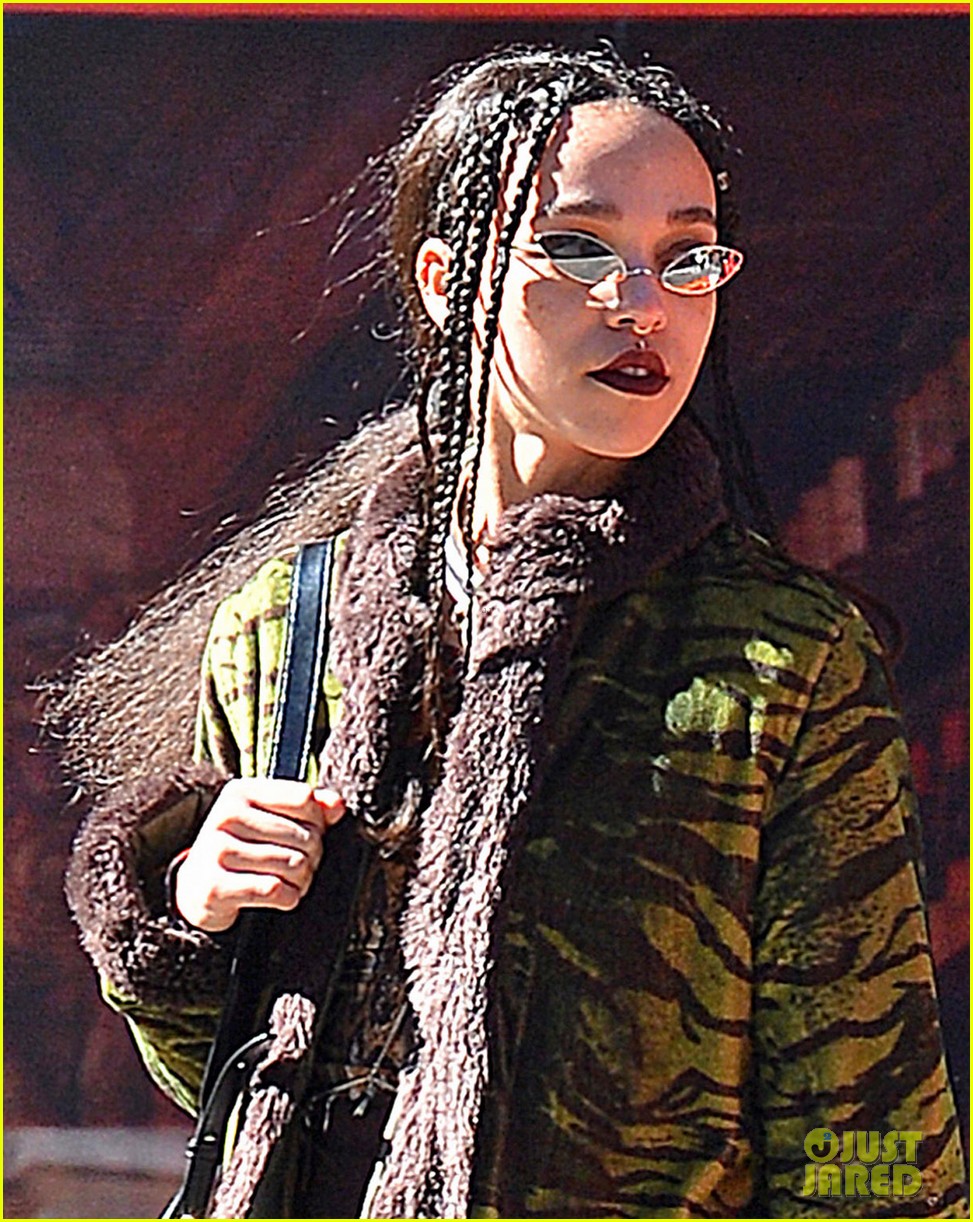 robert pattinsons fiancee fka twigs pairs a green tiger print coat with sneakers 03