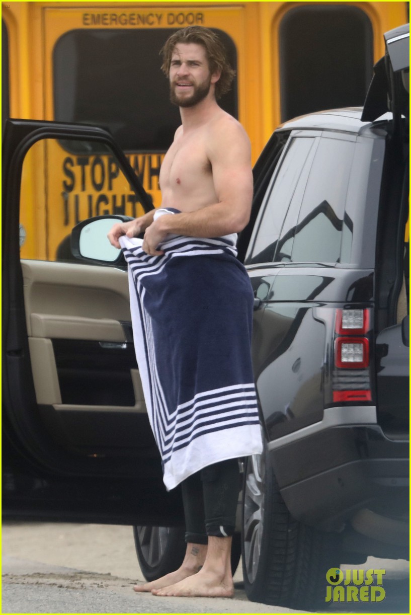 liam hemsworth strips out of wetsuit to reveal ripped abs 553917173