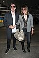 milla jovovich and paul ws anderson strike a silly pose at the airport2 01