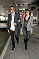 milla jovovich and paul ws anderson strike a silly pose at the airport2 03