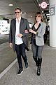 milla jovovich and paul ws anderson strike a silly pose at the airport2 05