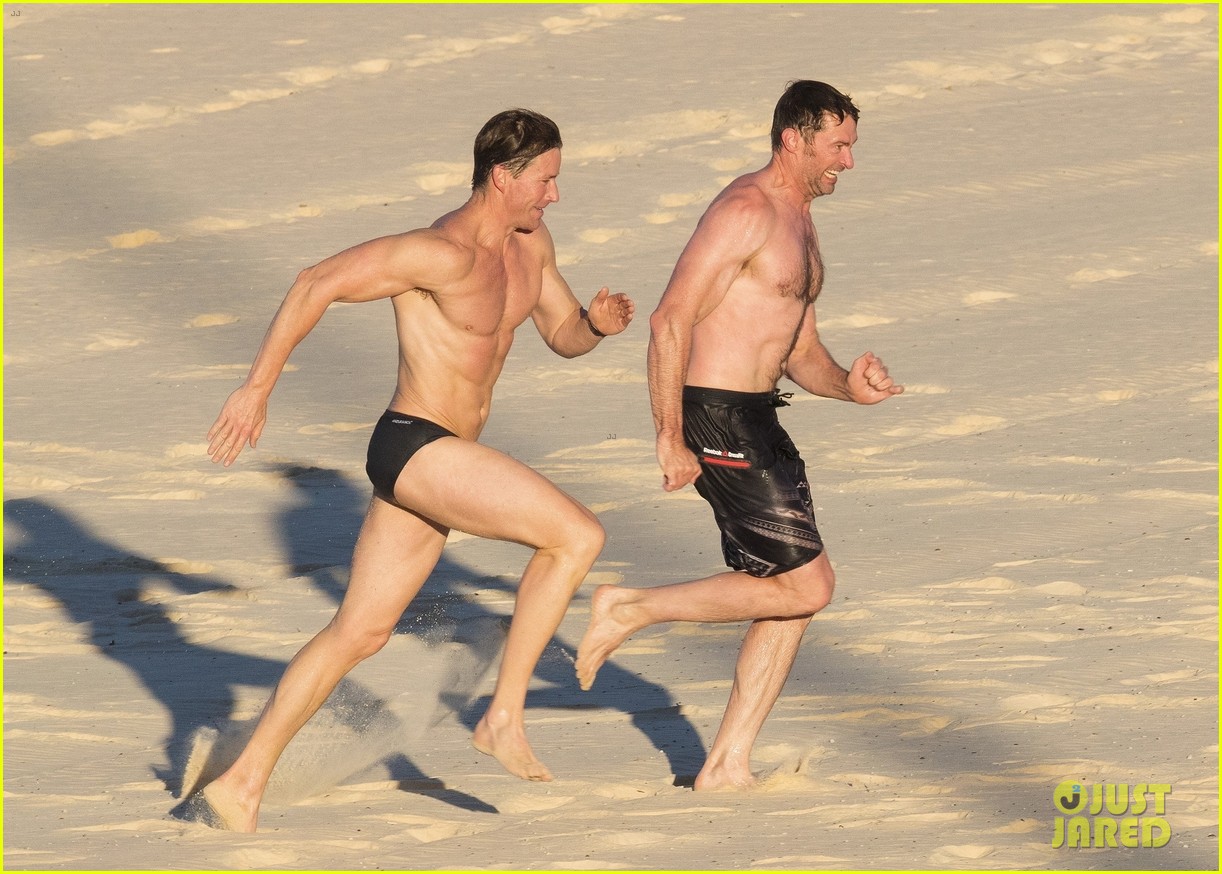 hugh jackman hits the beach with his speedo clad trainer 203935337