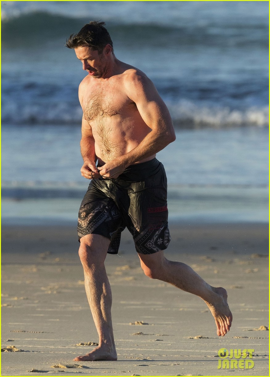 hugh jackman hits the beach with his speedo clad trainer 583935375