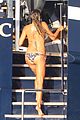 heidi klum rinses off in tiny colorful bikini with roses at her feet 03