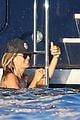 heidi klum rinses off in tiny colorful bikini with roses at her feet 05