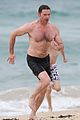 hugh jackman goes shirtless at the beach with his hot trainer 09