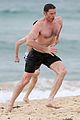 hugh jackman goes shirtless at the beach with his hot trainer 12
