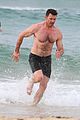 hugh jackman goes shirtless at the beach with his hot trainer 31