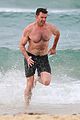 hugh jackman goes shirtless at the beach with his hot trainer 33