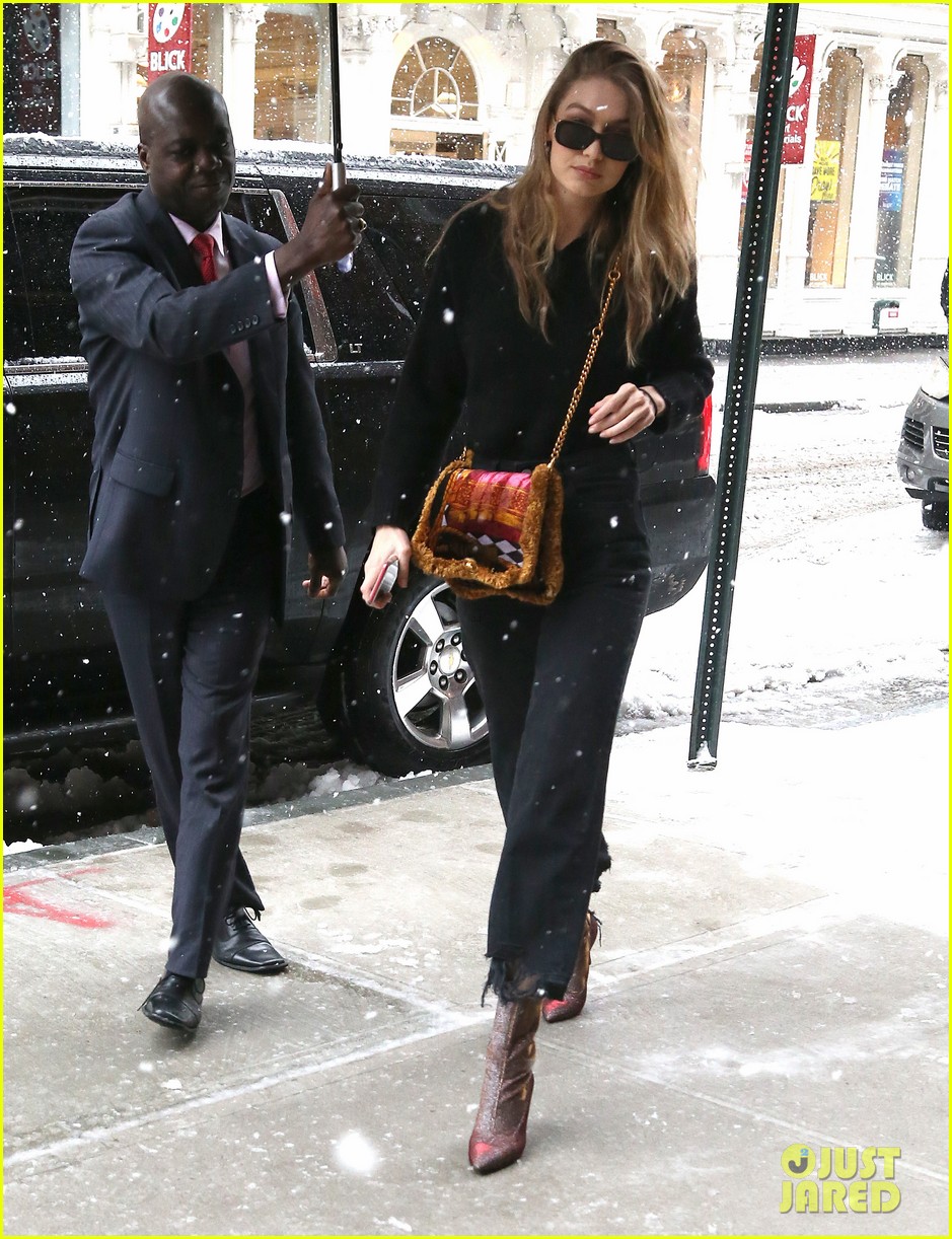 gigi hadid rocks colorful purse and boots while braving the snow 034053864