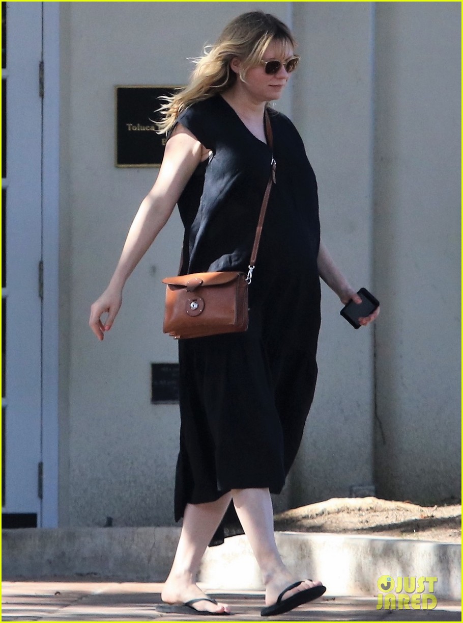 pregnant kirsten dunst covers up baby bump in black dress 12