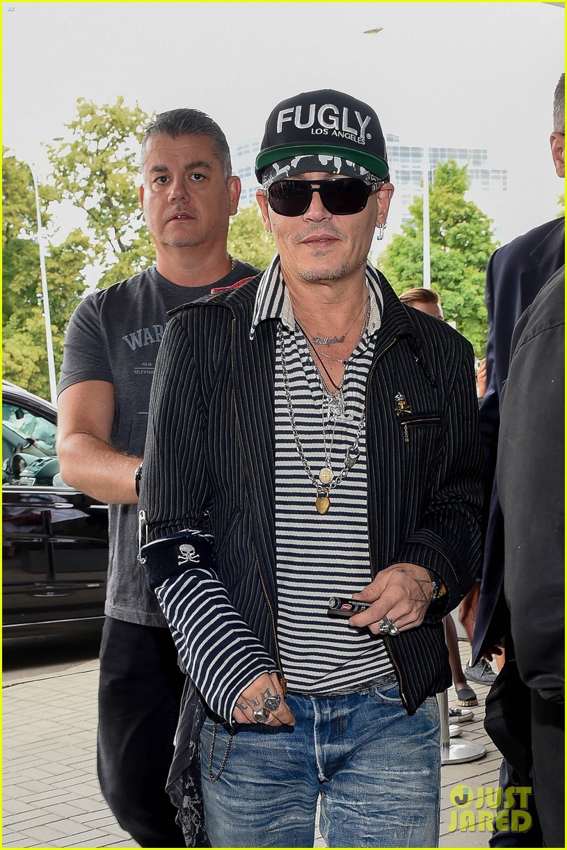 johnny depp greets fans while arriving at poland airport 044101151