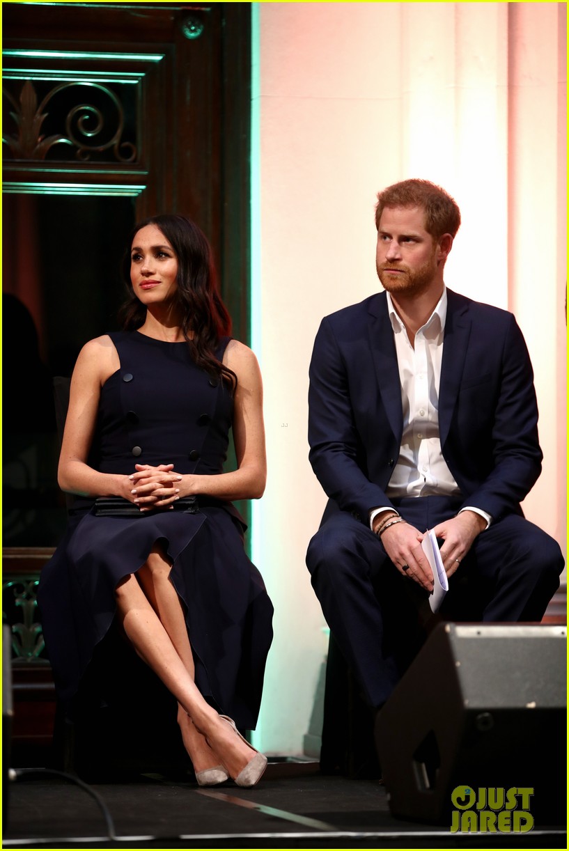 Duchess Meghan Markle Cradles Her Baby Bump During Outing with Prince